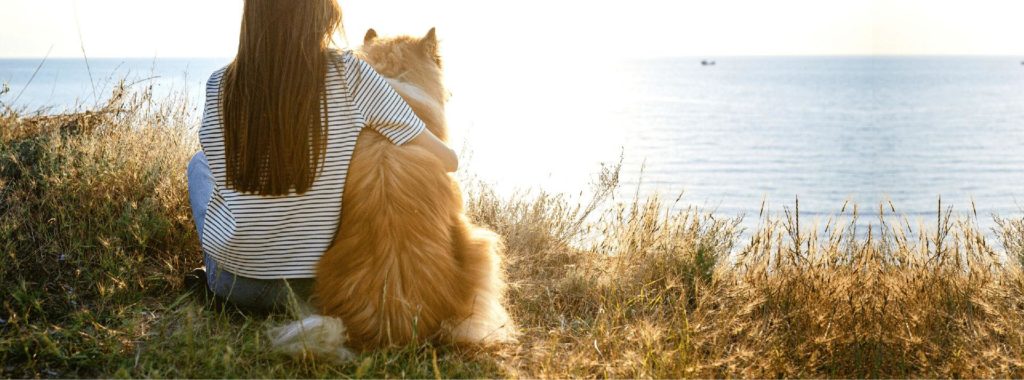 woman and dog looking at water