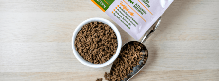 Cat food in a bowl and scoop