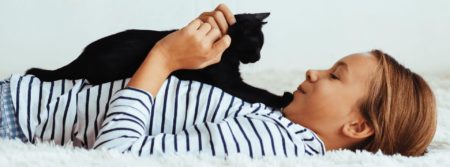 girl playing with kitten